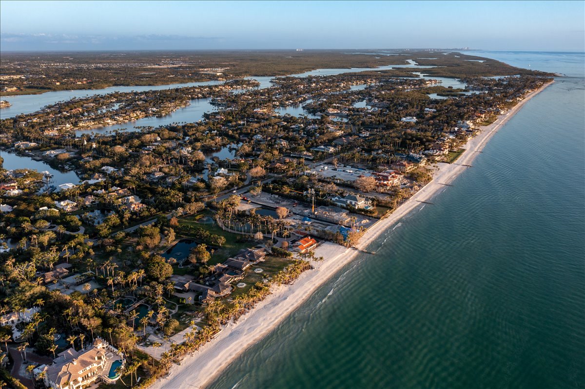 Long aerial view along the Naples coastline and Gulf