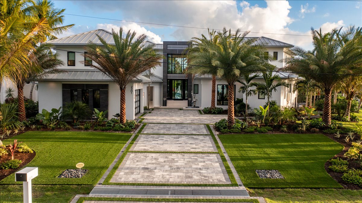 Daylight view of the modern entry framed by palms